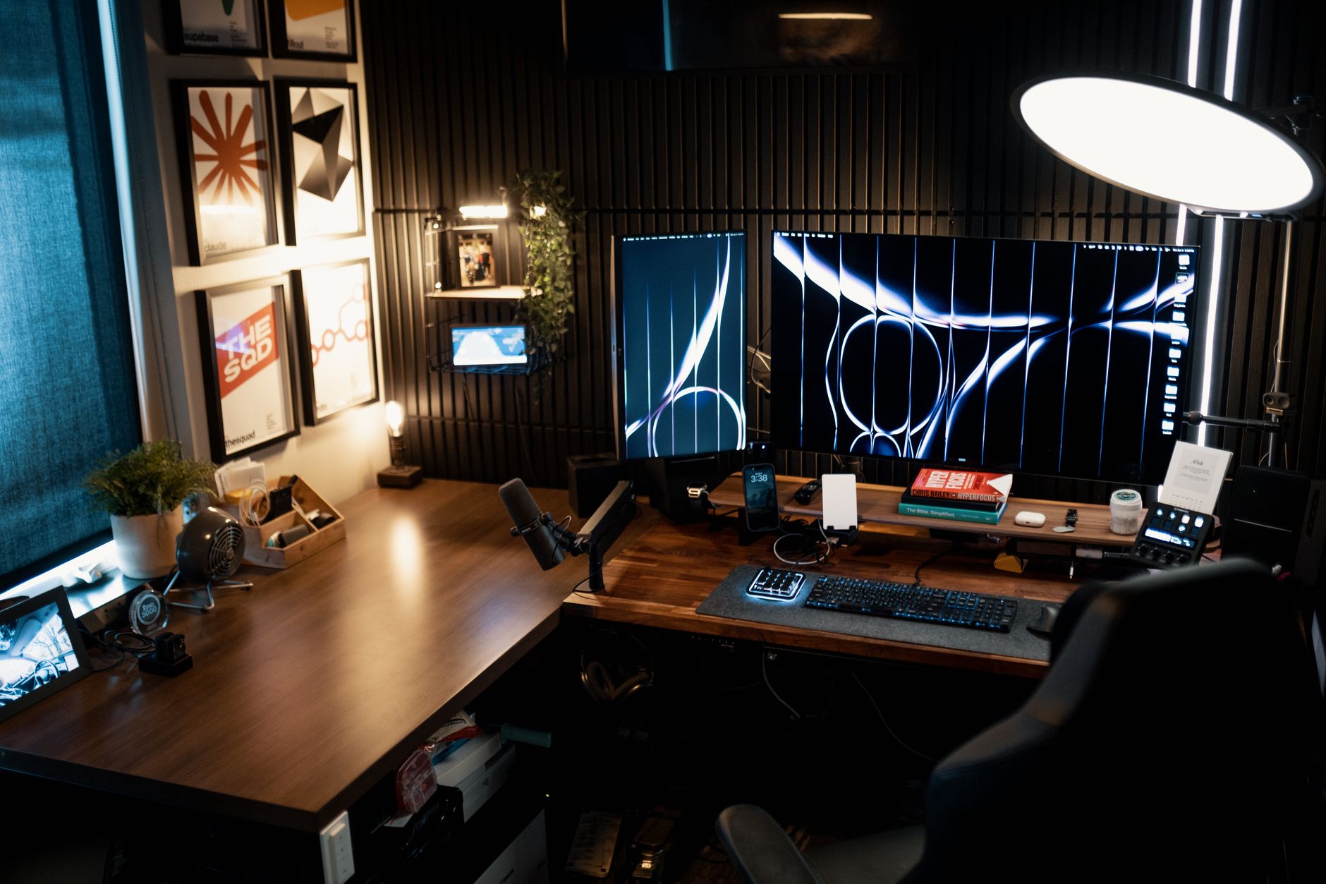 A cozy, modern home office with dual monitors and ambient lighting used for evening writing work.