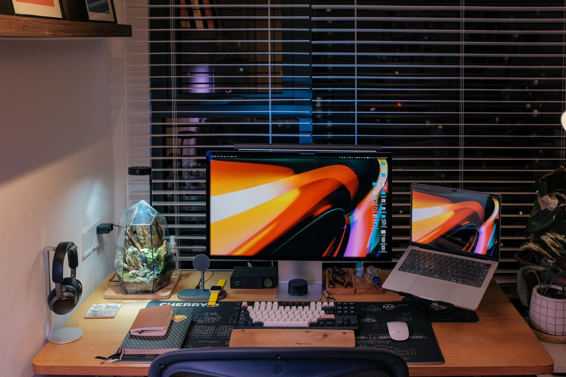 A stylish home office setup with dual monitors and gadgets, suitable for remote client work.